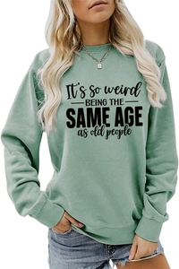 Close-up of it's so weird being the same age text on green drop shoulder sweatshirt