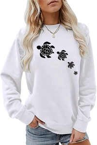 Close-up of white crewneck sweatshirt featuring a row of black sea turtle silhouettes