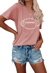 Close-up of pink Game Day graphic T-shirt paired with distressed denim shorts