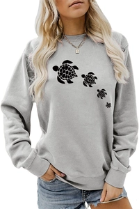 Detail of grey crewneck sweatshirt featuring a row of black sea turtle silhouette prints