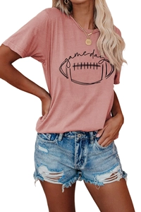 Detail shot of a pink t-shirt with a Game Day football print and ripped denim shorts