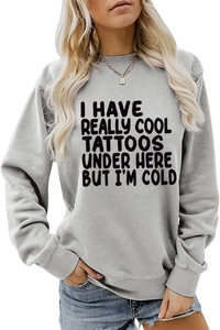 Close-up of grey long-sleeved sweatshirt featuring a bold black printed slogan detail