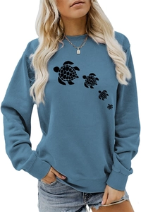 Detailed close-up of the turtle print on this blue crewneck long sleeve sweatshirt