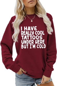Close-up of slogan print on a cozy burgundy crewneck sweatshirt for women