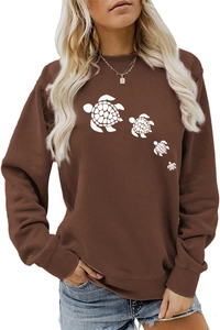 Detail of cute white turtle print on a premium brown crewneck long sleeve sweatshirt