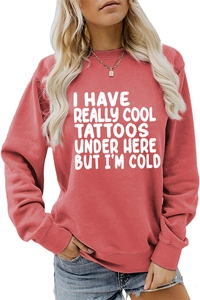 Detailed close-up of pink long-sleeved sweatshirt with white typography text print