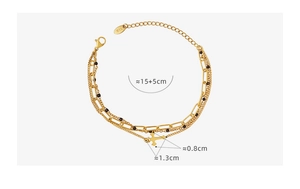 Macro detail of triple-layer gold titanium steel cross bracelet with size measurements