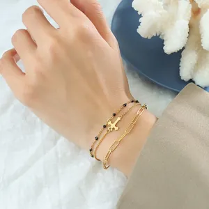 Three-layer 18k gold plated stainless steel cross charm bracelet set on female wrist