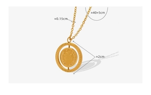 Detail view of double-sided spinning pig pendant with 'Nothing is impossible' engraving