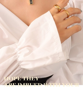 Detail showing the quilted gold ring and black acrylic pendant with G-letter engraving
