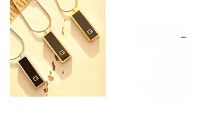 Detail of minimalist rectangular black enamel pendant necklace with gold letter G