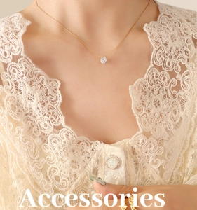Close-up of a four-prong round zircon solitaire pendant on a delicate gold chain necklace