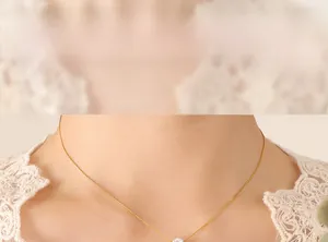 Close-up of zircon solitaire necklace on neck with delicate gold chain for women