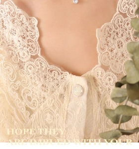 Close-up of a silver solitaire pendant necklace paired with a cream lace embroidered top