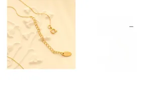 Detailed close-up of 18K gold necklace extension chain with K18 engraved metal tag