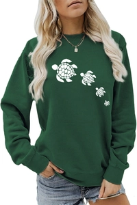 Close-up of the cute white sea turtle print on a casual dark green crewneck sweatshirt