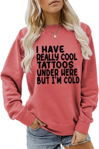 Close-up of brick red crewneck sweatshirt with black humorous tattoo slogan print