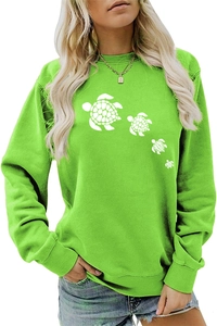 Detail of a bright green sweatshirt featuring white sea turtle prints and ribbed cuffs