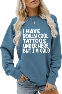 Detail of greyish-blue cotton sweatshirt featuring white art text print for cool tattoos
