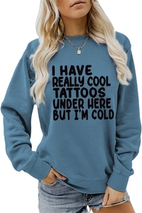 Close-up of blue crewneck sweatshirt featuring white typography and cotton blend texture