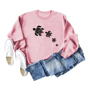 Pink crewneck sweatshirt with cute turtle print styled with denim shorts and sneakers