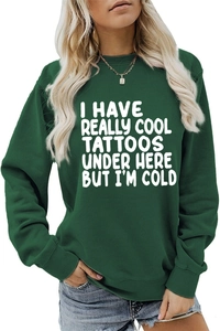 Detail of dark green crewneck sweatshirt with I HAVE REALLY COOL TATTOOS print and blue jeans