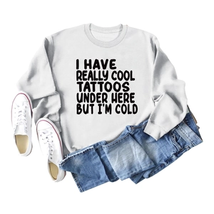 Flat lay of white long sleeve sweatshirt with I Have Really Cool Tattoos funny quote text