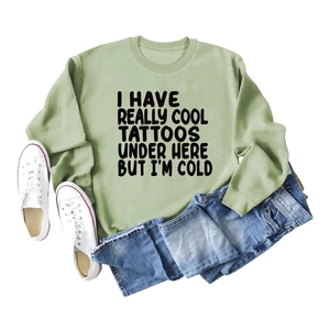 Sage green long sleeve crewneck sweatshirt with black Tattoos slogan print and denim jeans