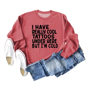 Red long sleeve crewneck sweatshirt with black text quote flat lay and jeans