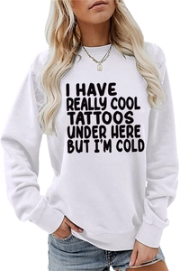 Detail of rib-knit cuffs and slogan print on a white crewneck long sleeve sweatshirt