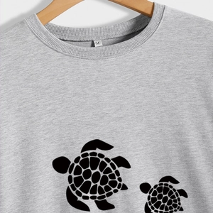 Light gray crewneck sweatshirt featuring a cute turtle print and soft cotton fabric