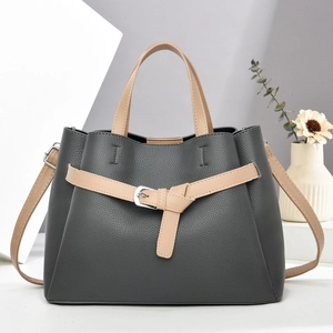 Detailed view of the dark grey pebbled leather tote with khaki handles and silver buckle