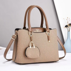 Detailed view of canvas tote bag interior with heart logo and mini coin purse detail