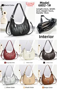 Detail view of retro checkered crescent bag showing PU leather texture and dimensions