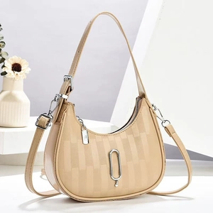 Chic beige crescent underarm bag with vertical stripe texture and silver metal detail