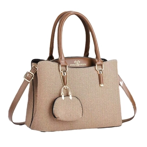 Contrast color canvas tote bag with brown leather trim and mini charm pouch