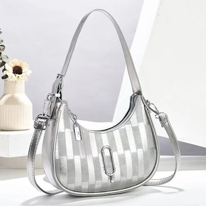 Silver crescent shoulder bag with vertical stripe embossing and minimalist metallic finish