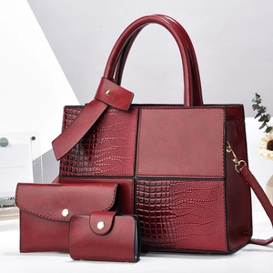 Three-piece handbag set detail showing dark red PU leather and crocodile texture contrast