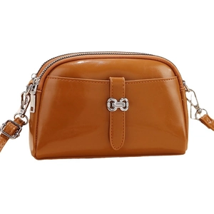Brown faux leather mini crossbody bag with glossy finish and silver buckle for women