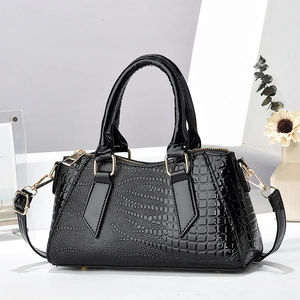 Glossy black crocodile-embossed pillow handbag with gold hardware and top handles