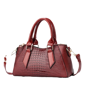 Glossy red crocodile embossed faux leather Boston bag with gold hardware and top handles