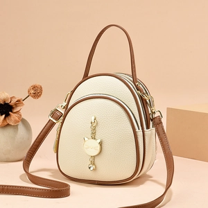 Elegant beige and brown multi-layer mini backpack with gold cat charm and strap