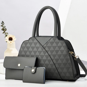 Detailed view of dark grey three-piece handbag set with elegant quilted texture and gold hardware