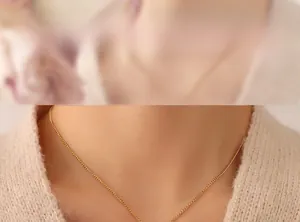 Detailed view of irregular 18K gold plated walnut texture pendant on thin chain