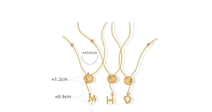 Detail of 18K gold plated Y-shaped necklace with MHD hollow pendant and tassels