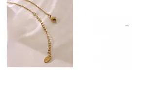 Detail of 18K gold plated titanium necklace clasp with K18 engraved tag and chain