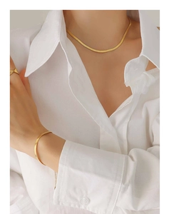 Close-up of 18K gold plated snake bone chain necklace and bracelet set on model