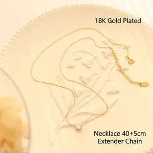 18K gold-plated necklace with sparkling solitaire zircon on a vintage ceramic plate