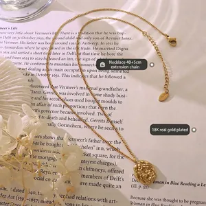 Irregular textured oval pendant necklace with 18K gold plating on a wavy chain