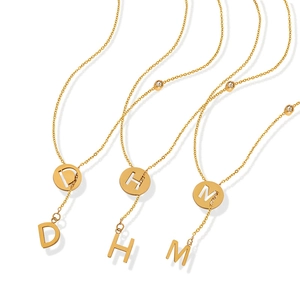 Golden Y-shaped tassel necklace with hollow letter charms and cubic zirconia accents